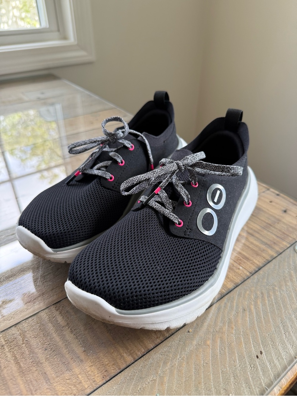 OOFOS Women's OOmy Stride sneakers in black with white soles